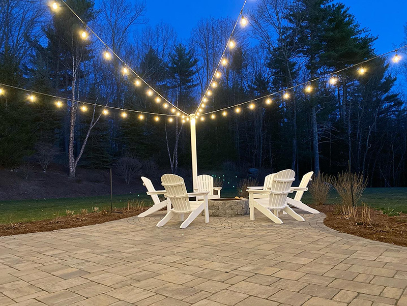 Outdoor chairs under bistro string lights